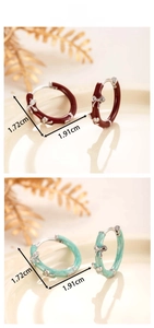 Detail of vintage enamel bow earrings in red and green marble with silver accents