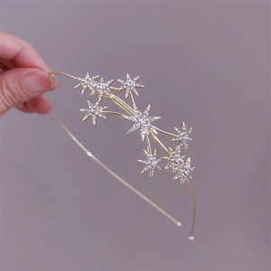 Elegant gold star headband for women featuring crystal rhinestones and pearl accents