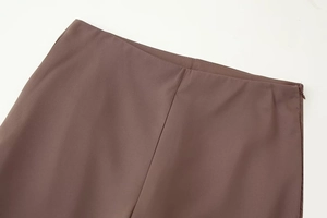 Close-up of brown woven high-waisted pants showing neat stitching and invisible side zipper