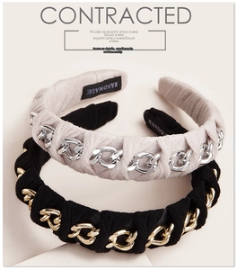 Detail of vintage suede headbands featuring metal chain weaving and handmade labels