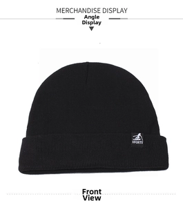 Detail of black knitted beanie showing close-up of sports logo patch and warm texture