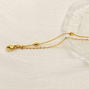 Double-layered 18K gold plated titanium steel chain with elegant oval beads and lobster clasp