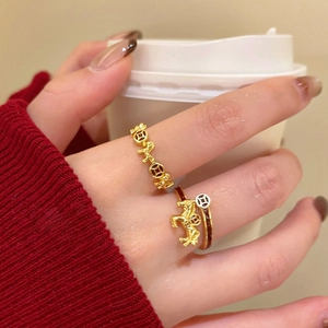 Detail of vintage gold plated open rings featuring horse and coin motifs for women