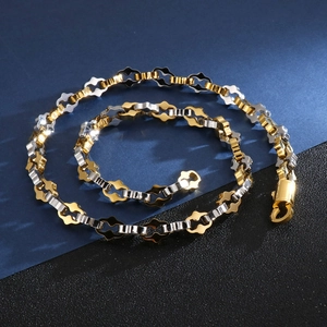 Close-up of dual-tone gold and silver geometric link chain with lobster clasp