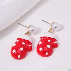 Detail of Christmas red glove earrings with white star motifs and pearl drops