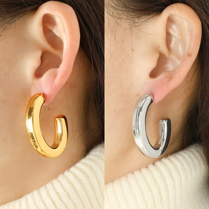Polished chunky C-shaped hoop earrings in gold and silver finish for a minimalist look