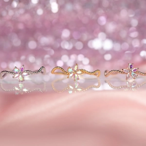 Floral wavy beaded rings in silver, gold, and rose gold with iridescent opal petals