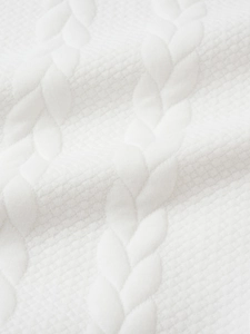 Macro shot of white cable knit pattern and honeycomb texture on men's warm sweater