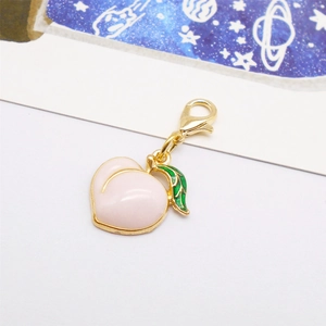 Pink peach enamel charm with gold metal frame, lobster clasp, and green leaf detail