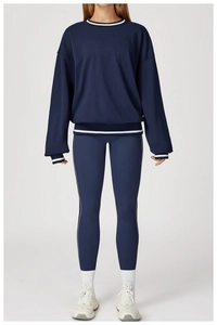 Detail of navy blue tracksuit with white striped cuffs and minimalist side piping