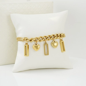 Minimalist 18K gold stainless steel bracelet with heart and rectangle charms on a pillow