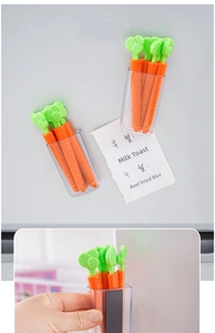 Carrot shaped food bag clips in a magnetic storage box attached to a refrigerator surface