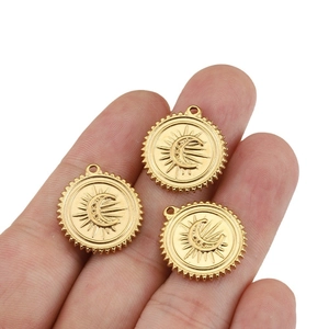 Three golden sun and crescent moon charms in a palm, crafted in stainless steel for DIY jewelry