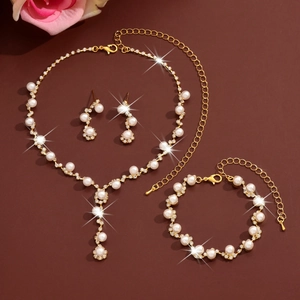 Detailed set of gold alloy jewelry featuring white pearls and sparkling rhinestones