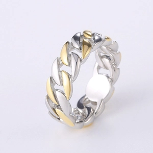 Close-up of Cuban chain link ring in two-tone silver and gold plated metal