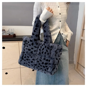 Detailed view of plush leopard print faux fur tote bag with soft winter texture