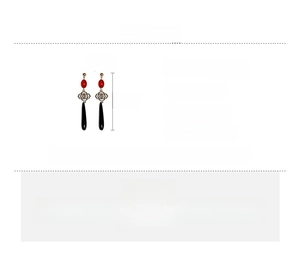 Detail shot of vintage Chinese knot style earrings with red beads and silver accents