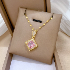 Detailed close-up of a titanium steel necklace with a pink square gem and white zircon