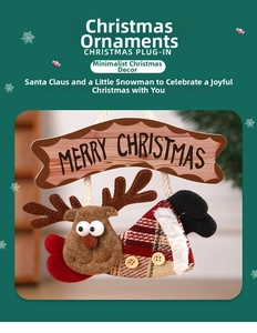 Close-up of reindeer plush ornament with wooden Merry Christmas sign and red plaid details