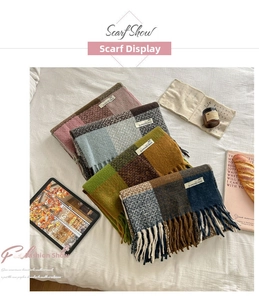 Close-up of thick checkered scarves with soft tassels and woven SUPERWOMAN labels