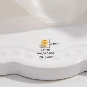 Macro detail of 2.3x2.6mm gold plated S925 silver faceted bead with 0.7mm hole