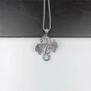 Vintage silver winged dragon pendant necklace with metallic chain for men on dual background