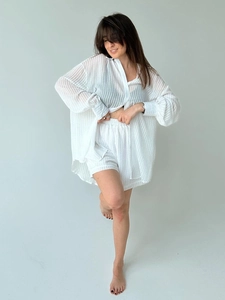 Detailed view of white textured striped fabric on a two-piece women's shirt and shorts set