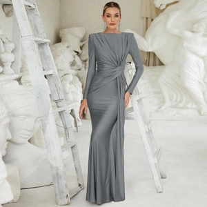 Detailed view of the knotted waist and silky grey fabric of the long sleeve evening gown