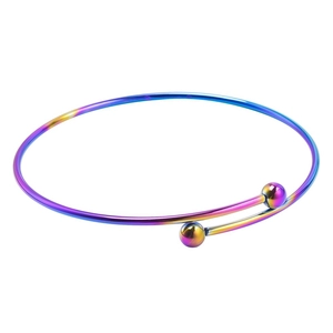 Rainbow plated stainless steel open bangle with spherical ends on white background