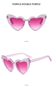 Detail view of heart-shaped sunglasses with rhinestones and purple gradient lenses