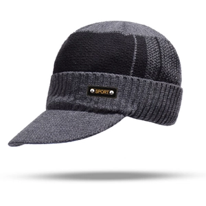 Detail of grey knitted jeep cap with sport label and warm ribbed texture finish