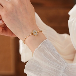 Détail du bracelet plaqué or 18 carats avec nacre blanche et gravure d'étoile