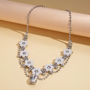 Detailed view of silver flower necklace with pearls, rhinestones and waterdrop pendant