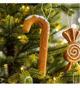 Close-up of candy cane and candy ornaments on a warm glowing Christmas tree