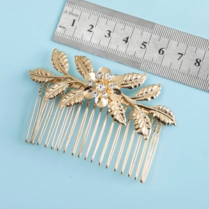 Detailed view of golden leaf hair comb with rhinestones measuring approximately 7.5cm width