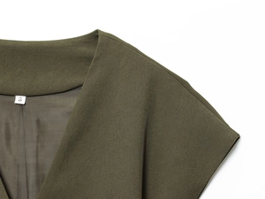 Detail of army green V-neck sleeveless top featuring clean stitching and size S label