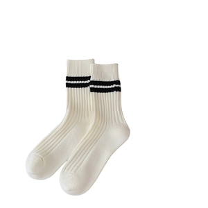 White combed cotton crew socks with black stripes in a thick knit varsity style