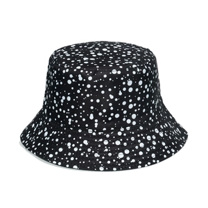 Women's reversible black sun hat with white polka dot patterns and reinforced stitching