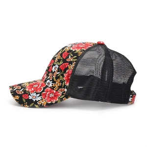 Detail view of floral print breathable mesh trucker hat with red flower pattern