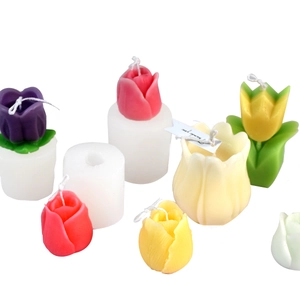 DIY tulip candle silicone molds with finished colorful floral candles on white background