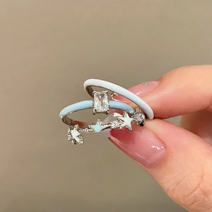 Two-piece set of silver rings with light blue enamel and sparkling star-shaped zirconias