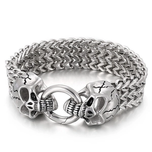 Detail of vintage men's stainless steel Franco link bracelet with carved wolf heads