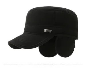 Detail view of winter black flat cap featuring ear flaps and premium corduroy fabric texture