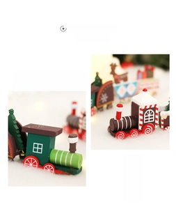 Close-up of wooden Christmas train with miniature trees and elk figures on snow