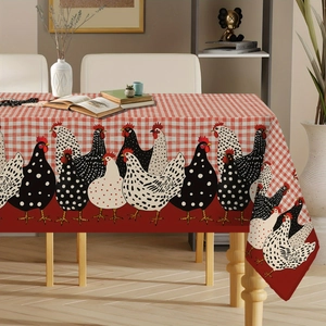 Detailed close-up of a rustic red gingham tablecloth with farm chicken motif on a wooden table