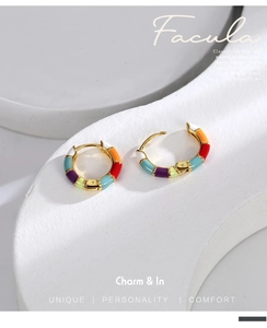 Detail of colorful enamel bamboo hoop earrings with vibrant multi-color segments