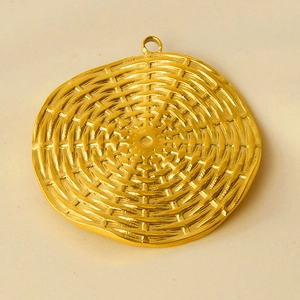 Detail of 18K gold plated round disc pendant with intricate woven texture and link ring