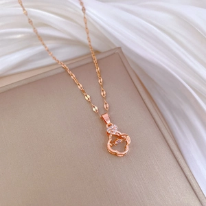 Elegant rose gold clover necklace with sparkling diamonds on smooth white silk