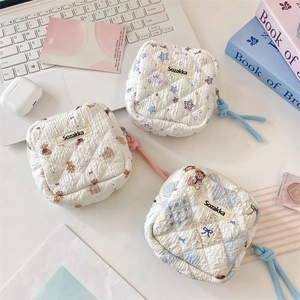 Detailed view of quilted cotton sanitary bags with bear and star patterns and zip closure
