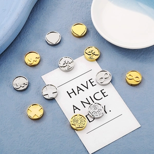 Detailed view of 15mm round stainless steel DIY charms in gold and silver plating